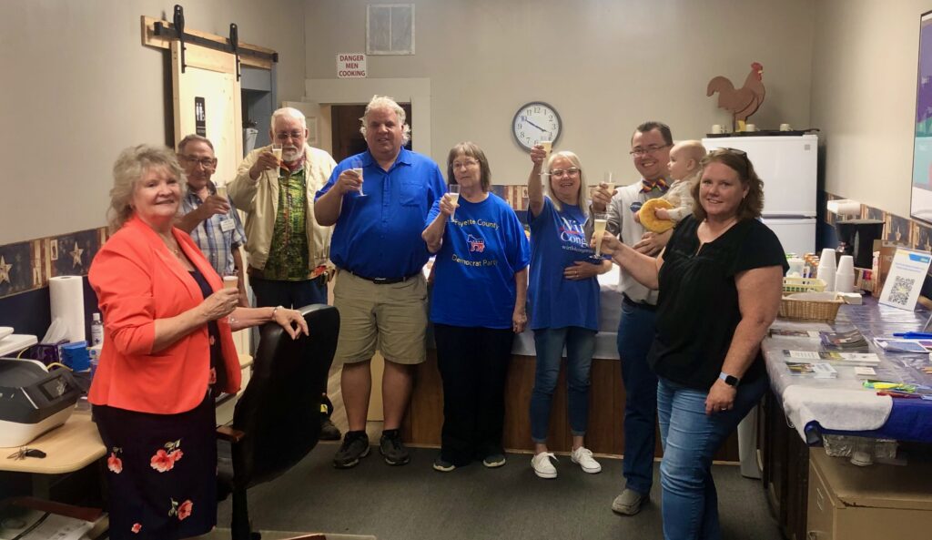 members of the Fayette County Democratic Party with Congressional candidate from Indiana's 6th District, Cinde Wirth, and her husband Trent Wirth, all raising a champaign toast to Wirth's campaign